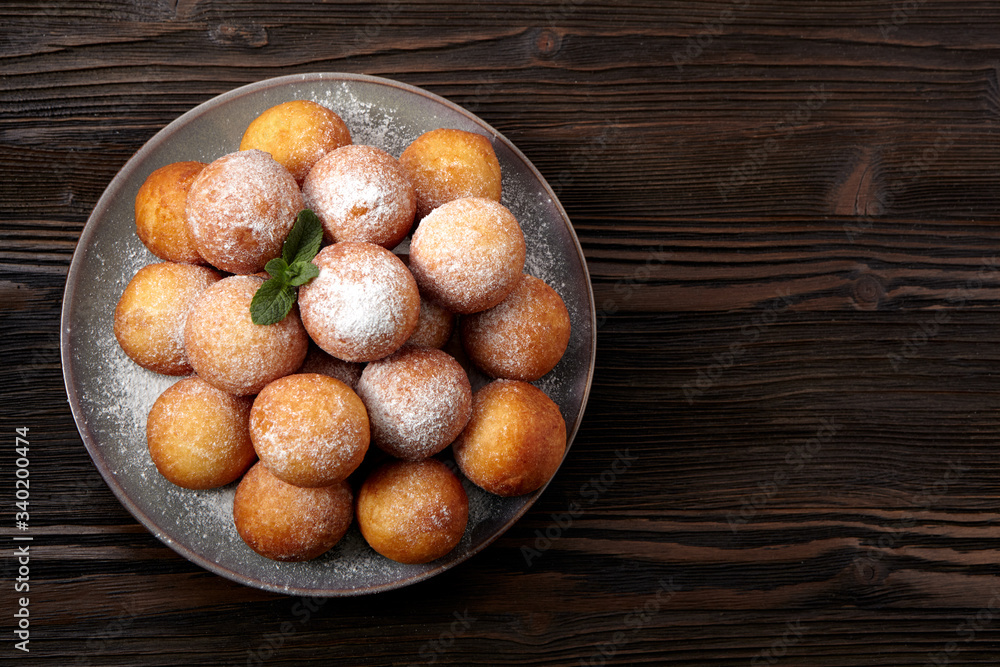 Rosy cheese balls on a dark wooden background. Top view. Rosy cheese balls on a dark wooden background. Top view.