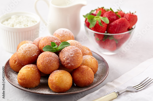 Beautiful breakfast. Cottage cheese donuts  balls  on a light background.