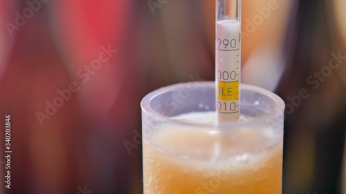 Tableau sur toile Using hydrometer to measure gravity of beer close-up