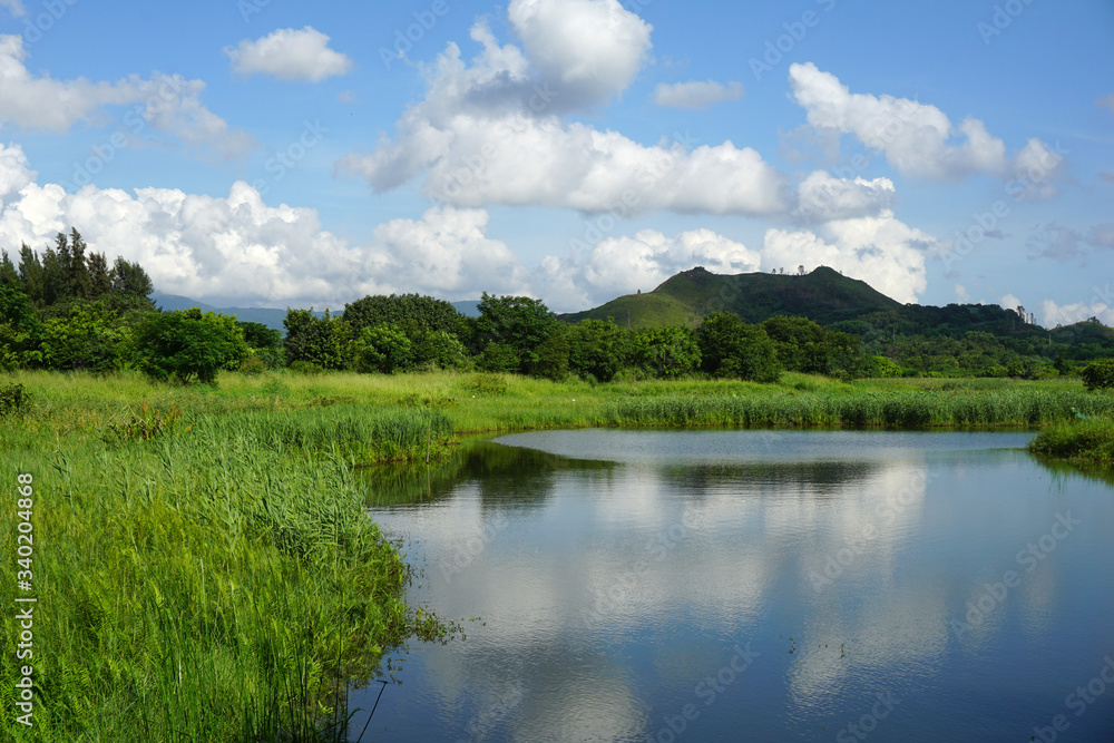 scenic view of lake and the mountains, Hong Kong Wetland Park scenic view of lake and the mountains, Hong Kong Wetland Park