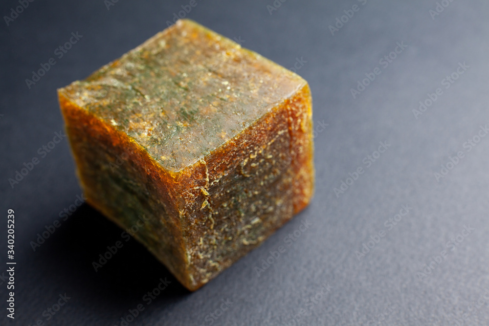 orange red cube synthetic rubber sample on a gray background shot close orange red cube synthetic rubber sample on a gray background shot close