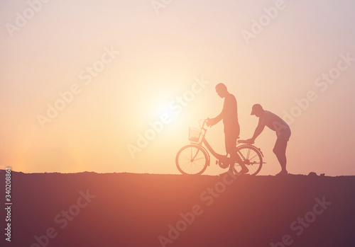 silhouette of couple driving bike happy time sunset © chaunpis