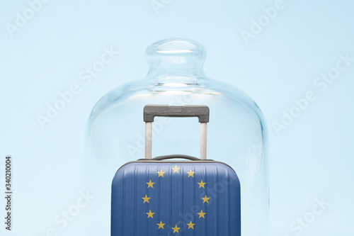 Luggage in isolation under glass cover covid-19 European Union tourism abstract.