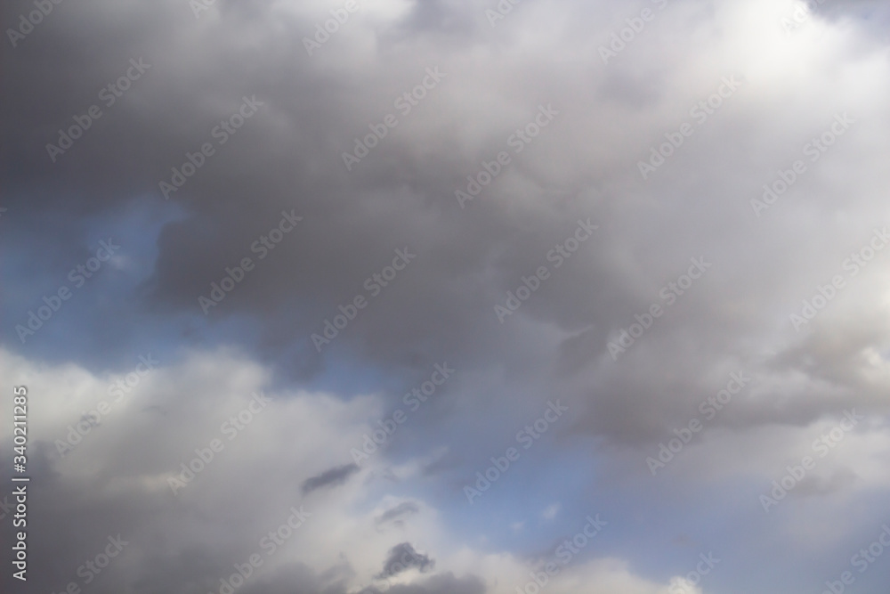 Clouds in the blue sky. A stunning gray sky. The storm is approaching. A beautiful clouds against the blue sky background. Amazing cloud pattern in the sky. Clouds in the blue sky. A stunning gray sky. The storm is approaching. A beautiful clouds against the blue sky background. Amazing cloud pattern in the sky.