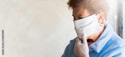 portrait of senior woman with disposable medical mask. Safety in public places during coronavirus outbreak. photo