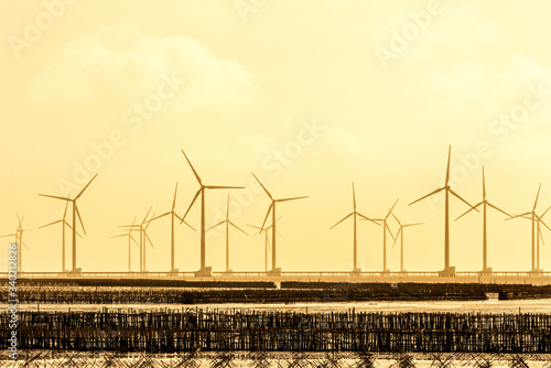 Seacape with Turbine Green Energy Electricity, Windmill for electric power production, Wind turbines generating electricity on the sea at  Bac Lieu, Vietnam. Clean energy concept photo