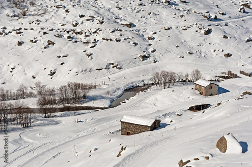Panoramic view down snow covered alpine valley with river © Paul Vinten