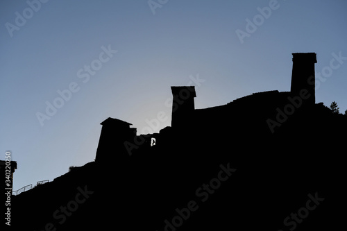 Silhouette of man walking in the the old fort of upper Omalo at sunset photo