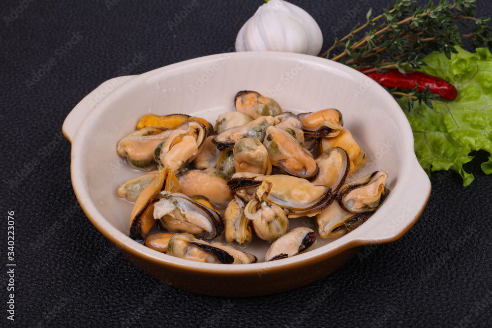 Pickled mussels in the bowl served pepper, garlic and salad Pickled mussels in the bowl served pepper, garlic and salad