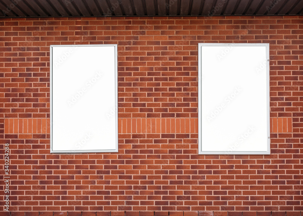 Blank / mockup billboard on a red brick wall Blank / mockup billboard on a red brick wall