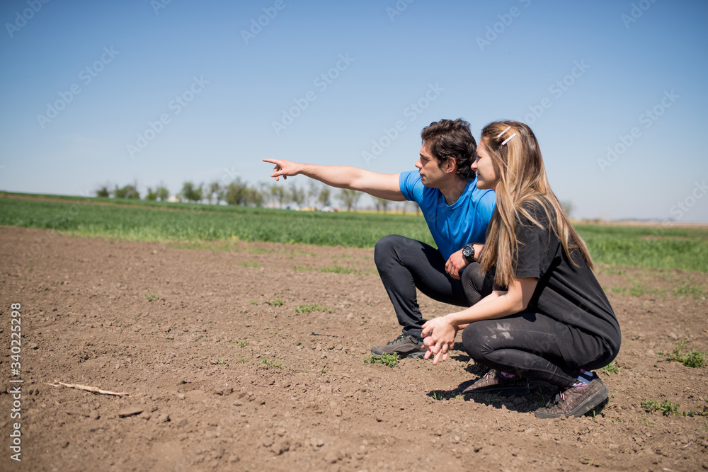 two young farmers discuss the production and sowing of corn on their fields two young farmers discuss the production and sowing of corn on their fields