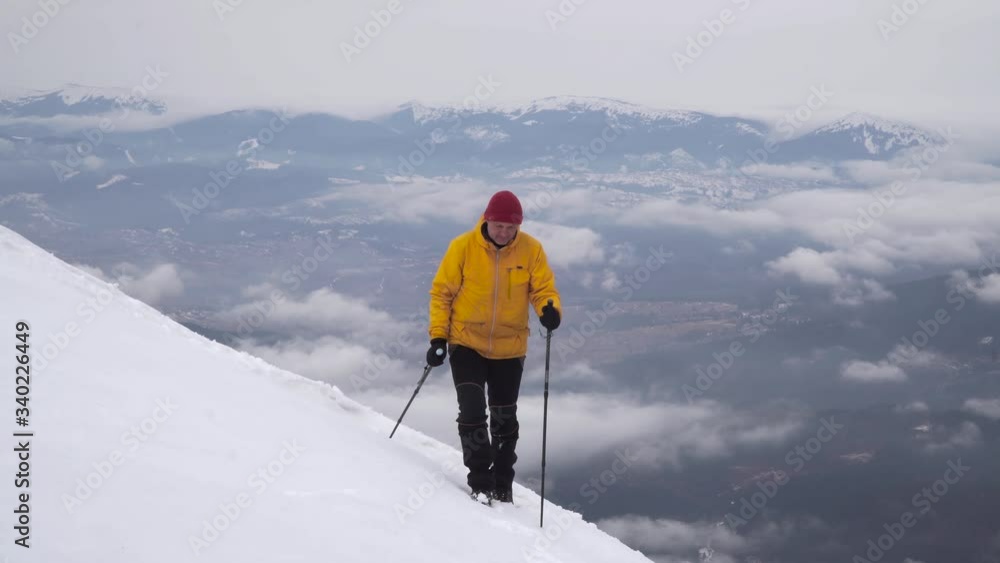 A traveler walks in the mountains in winter. The concept of travel and active lifestyle. 4K A traveler walks in the mountains in winter. The concept of travel and active lifestyle. 4K