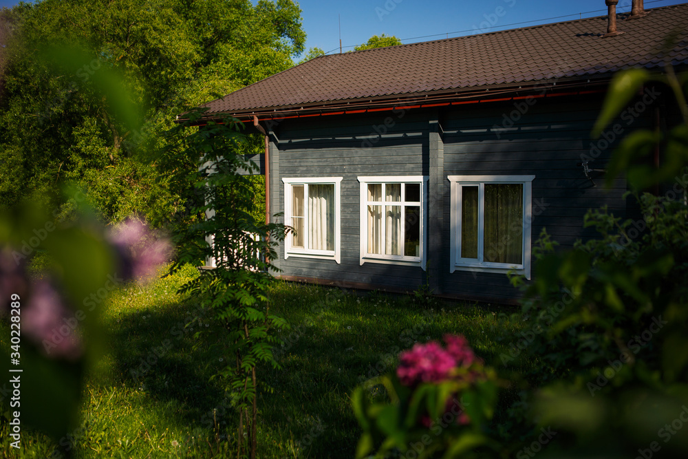 Golitsyno, Kaluga, Russia-may 18, 2019. Grey wooden holiday home in a picturesque forest eco-Park. Cozy road to a country house in the countryside. Spring-summer
