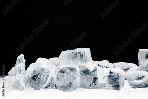 Frosted crushed ice cubes on black background.