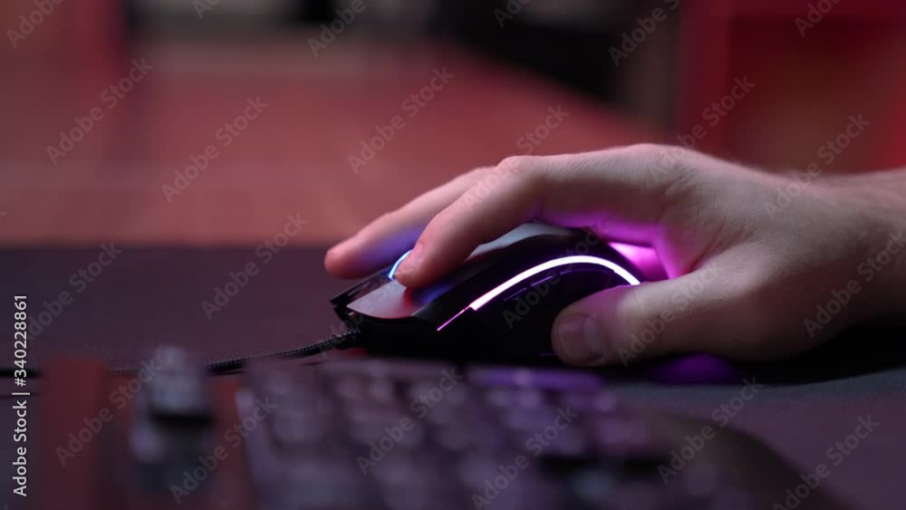 Gaming Device Mouse. A gamer is playing in a computer club. In the ...