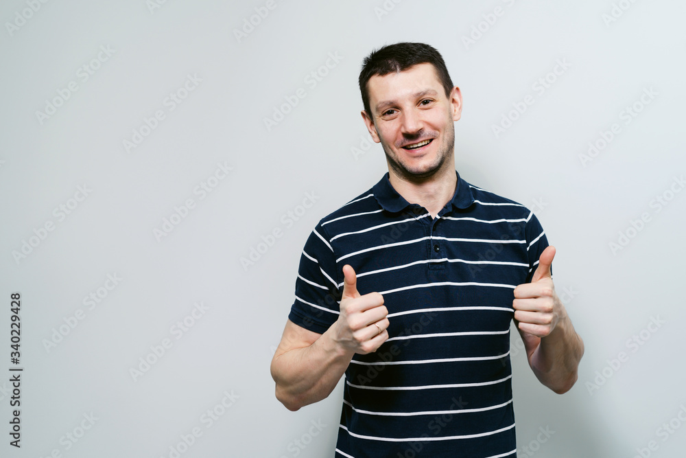 Man shows thumbs up. Satisfaction and joy. Young guy shows different emotions. Man shows thumbs up. Satisfaction and joy. Young guy shows different emotions.