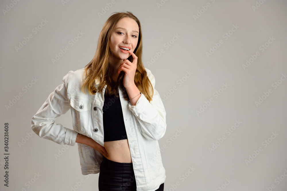 Studio portrait of a happy caucasian girl with smile in a white jacket on a white background Studio portrait of a happy caucasian girl with smile in a white jacket on a white background