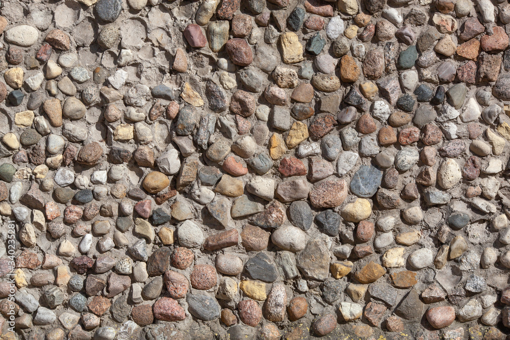 Stone wall texture, road made of small round stones Stone wall texture, road made of small round stones