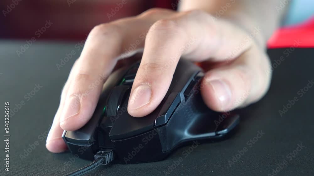 A gamer is playing in a computer club. In the frame, the hand of a gamer and a gaming mouse. Red and violet colors. ESports competitions.
A gamer is playing in a computer club. In the frame, the hand of a gamer and a gaming mouse. Red and violet colors. ESports competitions.