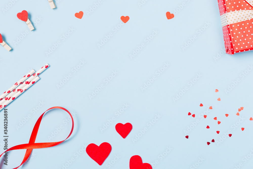 Gift box, confetti, hearts and envelope with free space for text on pastel blue background. Valentines day concept. Mother's Day concept. Greetings. Copy space. Flat lay, top view. Gift box, confetti, hearts and envelope with free space for text on pastel blue background. Valentines day concept. Mother's Day concept. Greetings. Copy space. Flat lay, top view.