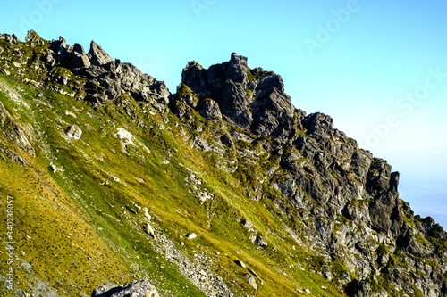 Sunrise on Fagaras high mountain ridge. Romanian mountain landscape with high peaks over 2200m photo