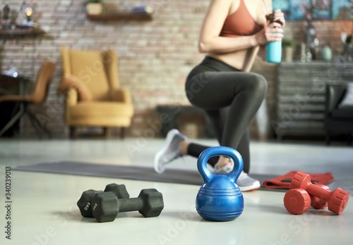 Fototapeta Naklejka Na Ścianę i Meble -  Fitness equipments at home. Focus on fitness tools, barbell and kettlebell. Concepts about home workout, fitness, sport and health.