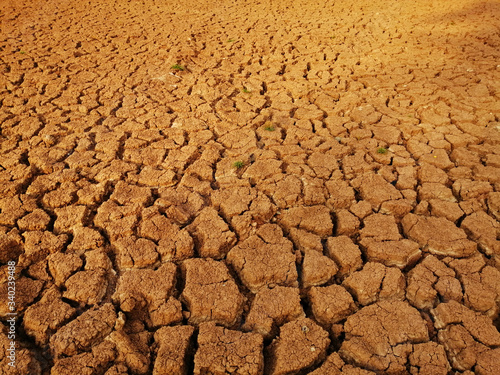Cracked ground Caused by drought or dryness. the ground was cracked. caused by drought No water for consumption. Summer drought. Dead aquatic animals. The soil is cracked.