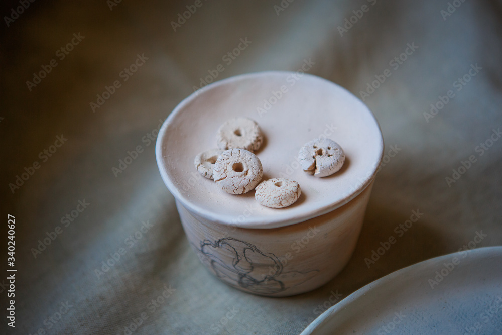 Golitsyno, Kaluga, Russia-may 18, 2019. Clay blanks for children's creativity at the master class in eco-Park. Layout on the table of clay vessels, plates, buttons Golitsyno, Kaluga, Russia-may 18, 2019. Clay blanks for children's creativity at the master class in eco-Park. Layout on the table of clay vessels, plates, buttons