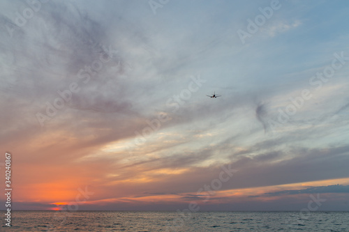 sunset over the sea with ariplane 