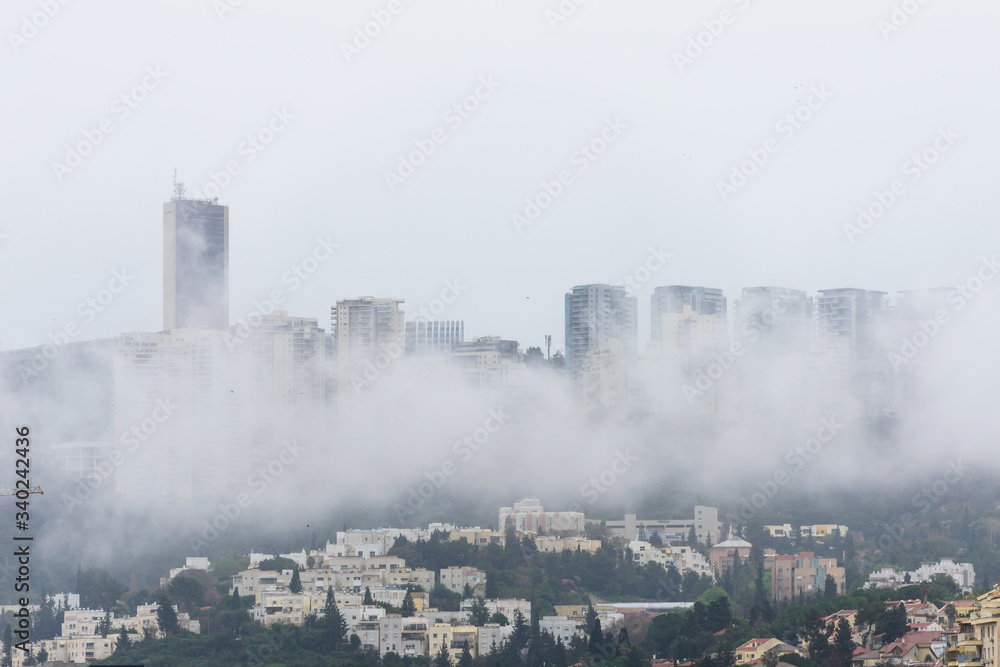 Haifa University (the highest building on the left) and its surrounding area obscured by fog on a somber spring morning