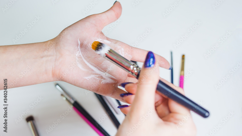 Cleaning and care of makeup brushes, women's hands wash the brush from cosmetics, Cleaning and care of makeup brushes, women's hands wash the brush from cosmetics,