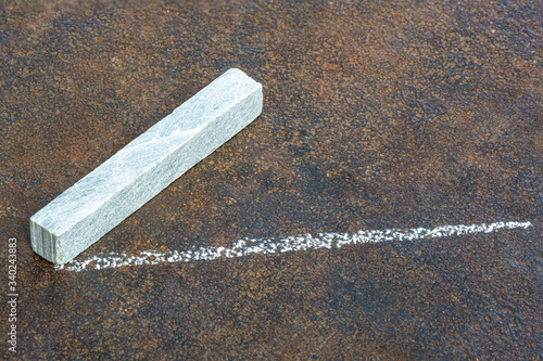 Engineering Chalk and marked line on worn steel plate. Used by Boilermakers and Welders as it resists heat. Fabrication marking up.