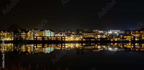 A beutiful water reflection of the city of Skanderborg in Denmark by night at a lake