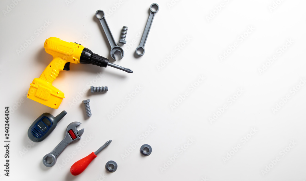 Top view. Plastic mechanic children Tool flat lay background. Space for text design. Mechanic Tools toy on white background Top view. Plastic mechanic children Tool flat lay background. Space for text design. Mechanic Tools toy on white background