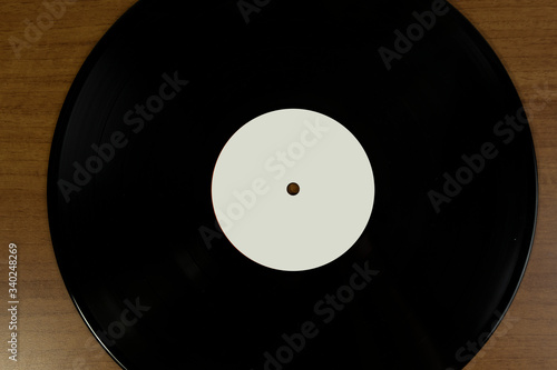Close up of empty white tag Vinyl disk in a wood background for mockup purposes