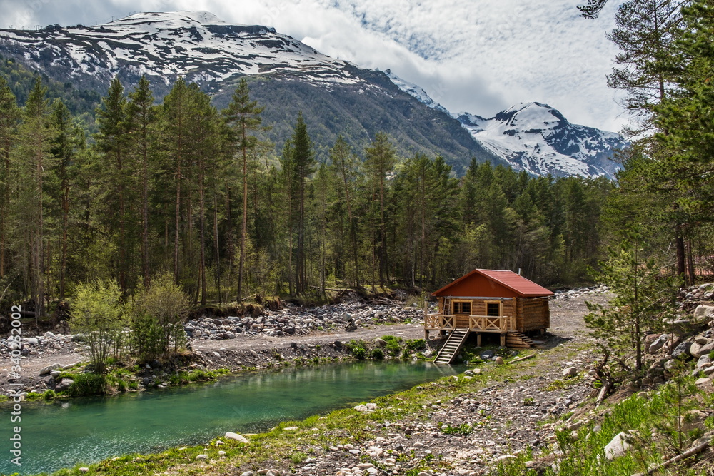 House by the pond in the mountains. Elbrus region.