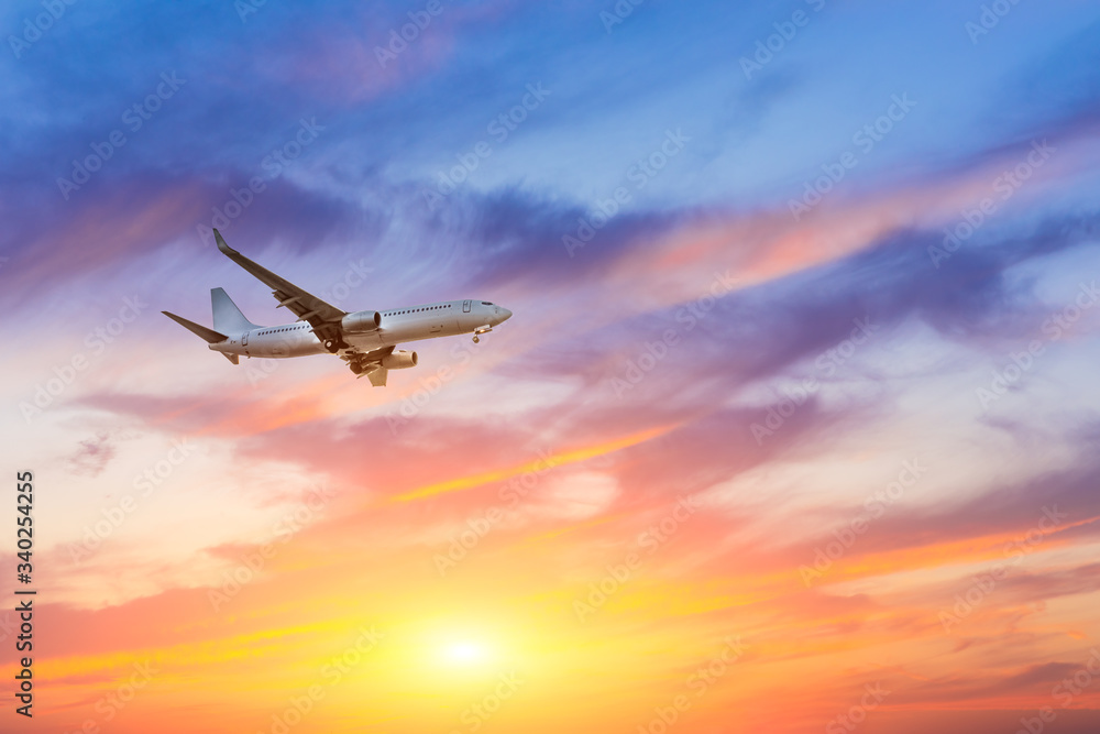 Obraz premium Commercial airplane flying in beautiful sky at sunset,travel concept.