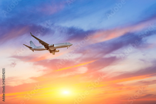 Commercial airplane flying in beautiful sky at sunset,travel concept. © ABCDstock