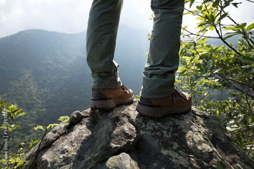 Successful hiker enjoy the view on mountain top cliff edge Successful hiker enjoy the view on mountain top cliff edge