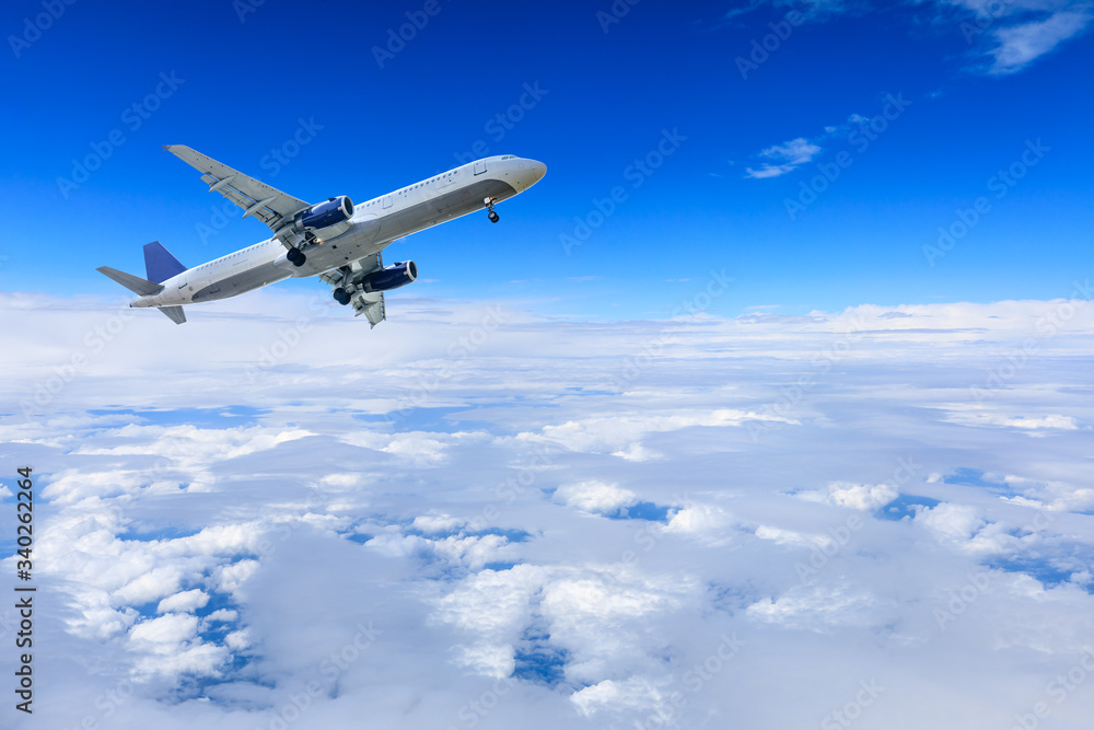 Fototapeta premium Commercial airplane flying above the clouds,travel concept.