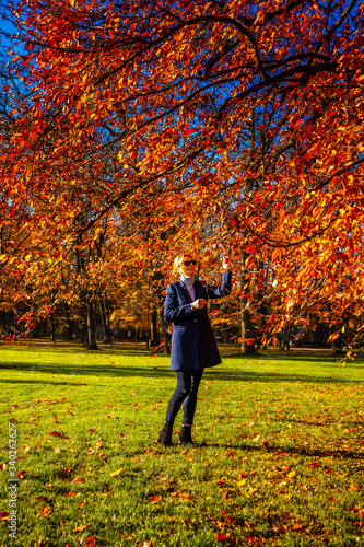 Middle-aged woman walking in city park  © Jacek Chabraszewski