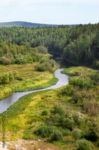 Beautiful landscape of Russian nature  view from the mountain to the forest and river on a sunny summer day