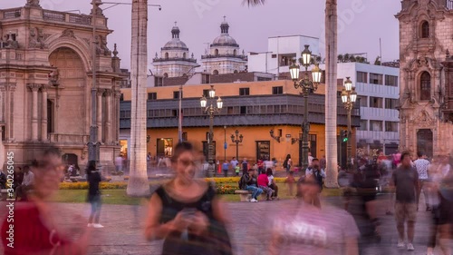 The Plaza de Armas day to night transition timelapse, also known as the Plaza Mayor, sits at the heart of Lima's historic center. Colorful houses on a background photo