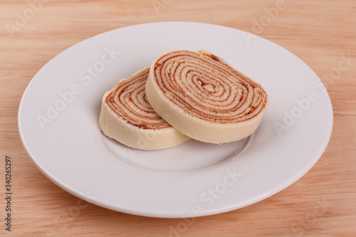 Swiss roll (cake) with red berry jam photo