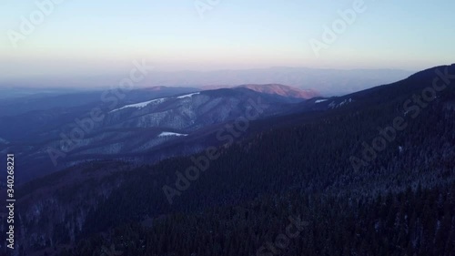 The dark, beautiful colors of the early sunrise over the mountain range of Romania - aerial photo