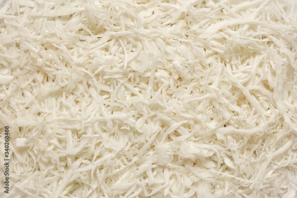 Sliced white fresh cabbage laid out on a table Sliced white fresh cabbage laid out on a table