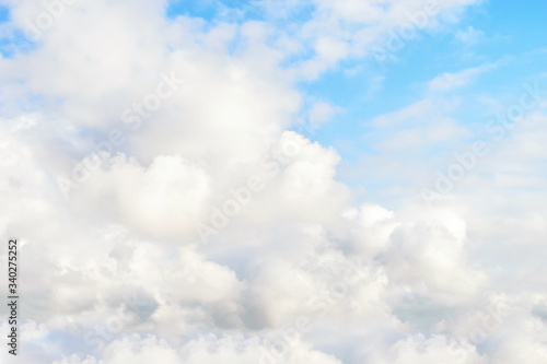 Blue textured sky with white cumulus clouds. Nice sky background.