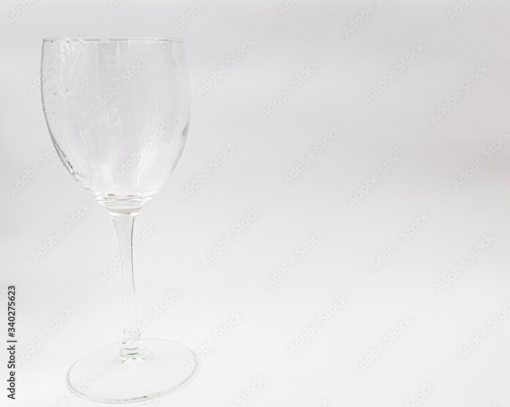 Clean wine glass on a white background. Place for text Clean wine glass on a white background. Place for text