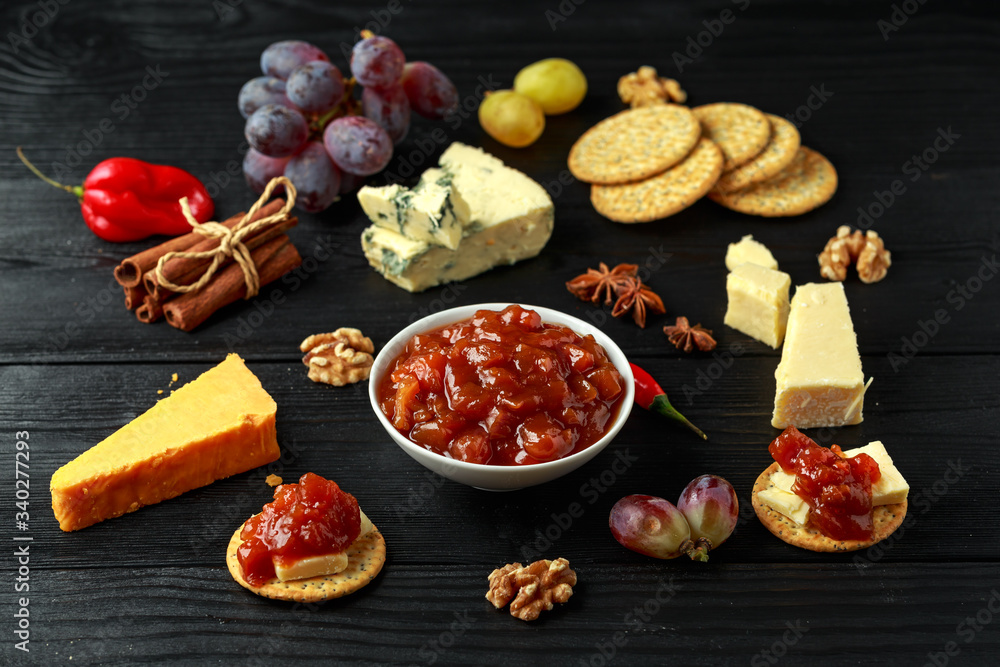 Homemade apple and chilli chutney with cheese, snack, nuts, fruits Homemade apple and chilli chutney with cheese, snack, nuts, fruits