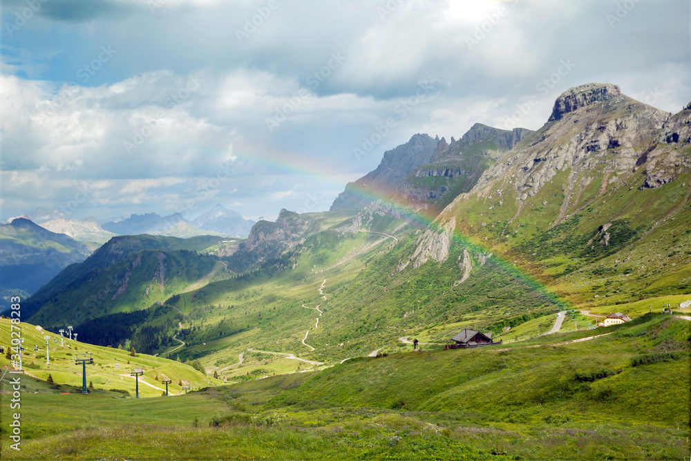 Fototapeta premium rainbow in summer mountains, Italy